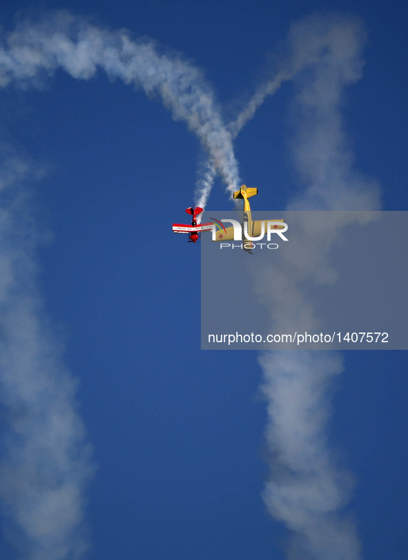 Two planes fly during an acrobatic show at the 5th Shenyang Faku International Flight Conference held in Faku County of Shenyang, capital of...