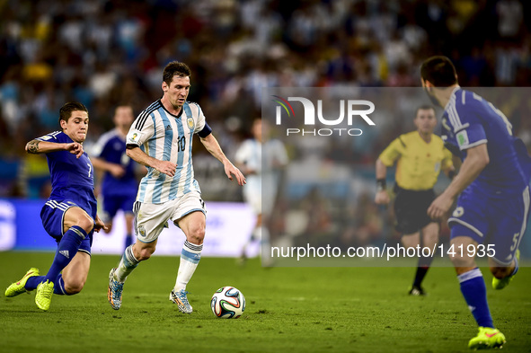 Lionel Messi (10) is followed by Muhamed Besic (7) at the match #11 of the 2014 World Cup, between Argentina and Bosnia-Herzegovina, this Su...