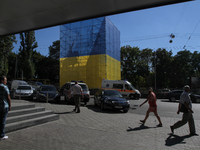 People walk by a monument of Shchors downtown Kiev, Ukraine on 7 September 2016. Kiev prepares to 