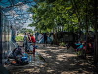 Refugees at a makeshift refugee camp on the Serbian side of the border with Hungary near the town of Horgos on August 12, 2016. (