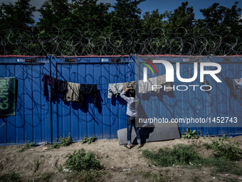 A refugee man at a makeshift refugee camp on the Serbian side of the border with Hungary near the town of Horgos on August 12, 2016. (
