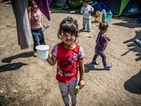 A refugee girl at a makeshift refugee camp on the Serbian side of the border with Hungary near the town of Horgos on August 12, 2016. (