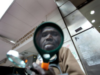 African immigrant selling magnifying glasses, Athens, Greece, Feb 2, 2011 (Photo by Giorgos Georgiou/NurPhoto)
