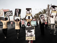 Bahrain , Shakhura - thousands attended opposition demonstration , protesters raised slogans demanding to release martyr Abdulaziz AlAbbar b...