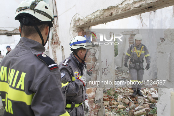 Rescuers search at hypothetic earthquake ruins during an earthquake exercise held in Bucharest, Romania, Nov. 1, 2016.   