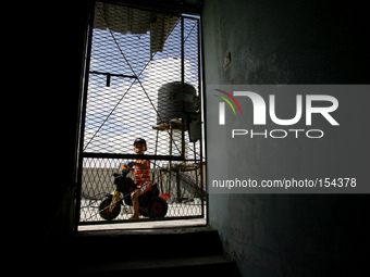 A Palestinian child in their home a near of the sea beach in the central Gaza Strip on June 26, 2014. Palestinian Environment Quality Author...