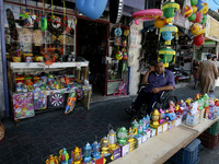 A Palestinian shop for imported traditional Ramadan lanterns at a market in Rafah in the southern Gaza Strip on June 28, 2014. Starting on S...