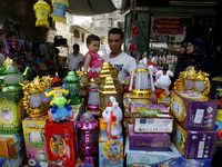 A Palestinian man carries his son and buys her lantern traditional Ramadan at a market in Rafah in the southern Gaza Strip on June 28, 2014....