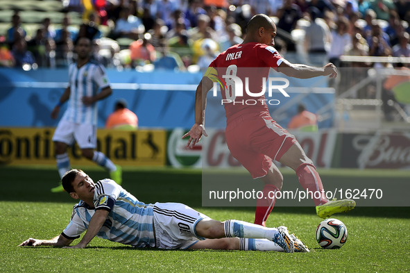 Lionel Messi (10) tackles Gokhan Inler (8) at the match #55, for the Round of 16 of the 2014 World Cup, between Argentina and Switzerland, t...