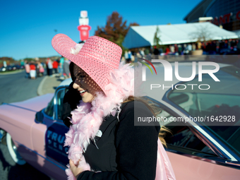 A woman poses in pink attire, in front of a 1959 Pink Cadillac, parked outside a Nov. 4, 2016 rally of Republican presidential candidate Don...