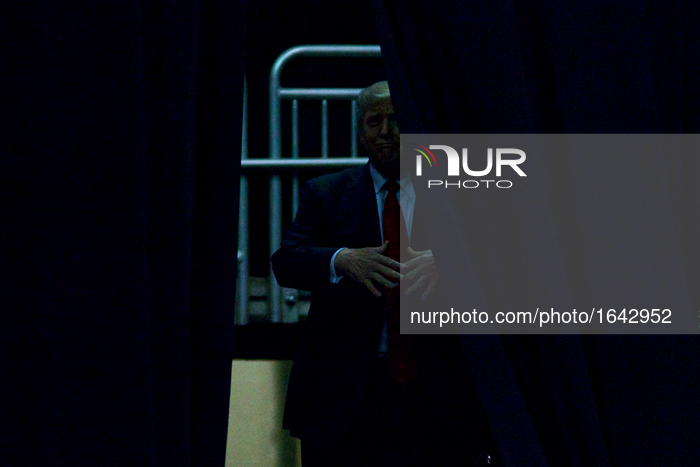 Republican presidential candidate Donald Trump waits behind a curtain as he is about total the stage at a rally at the Giant Center in Hersh...