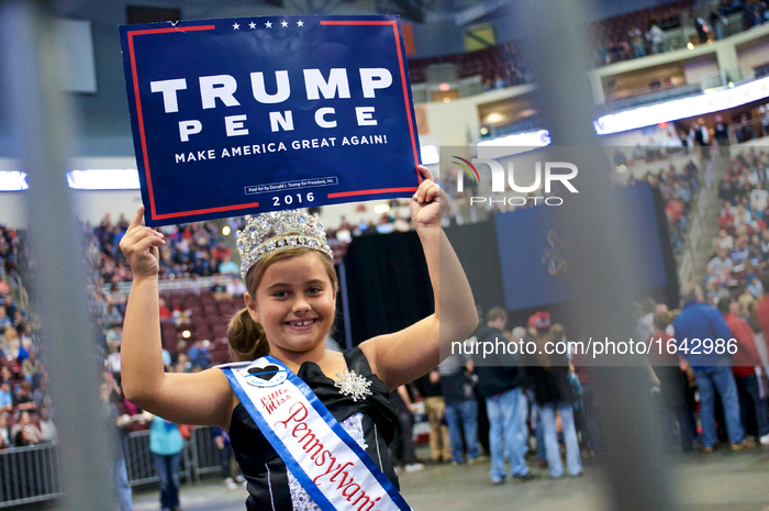 Little Miss PA East Coast USA Alexis Martz, 9, holds up a sign in support of the Republican ticket at a rally at the Giant Center in Hershey...