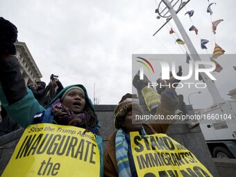 Protests and supporters gather as Donald Trump takes the oath of office and becomes the 45th President of the United States, during the Janu...