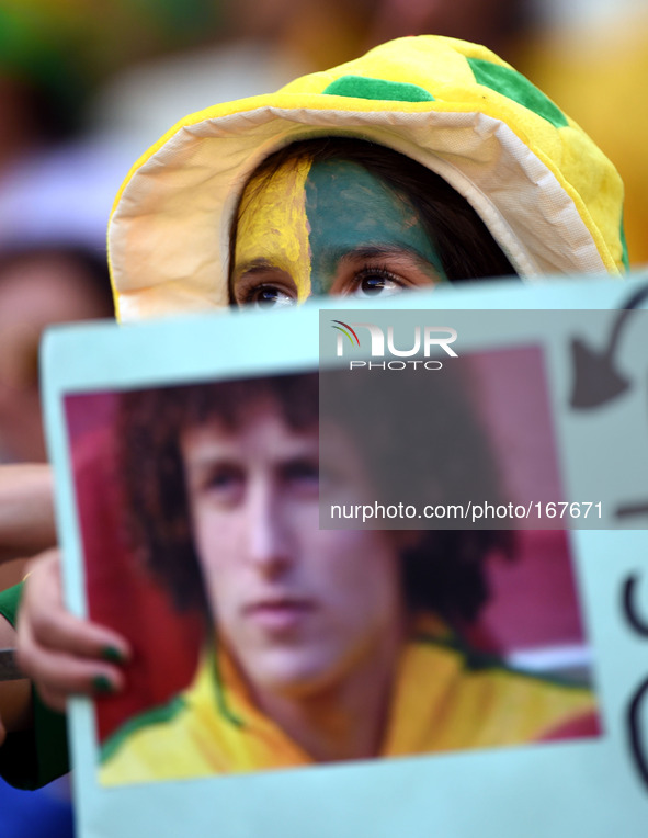 (140704) -- FORTALEZA, July 4, 2014 () -- A Brazil's fan holds a photo of David Luiz before a quarter-finals match between Brazil and Colomb...