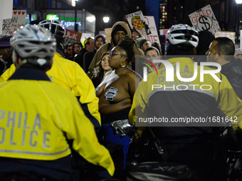Erica Mines of Philly Coalition of Real Justice (Center) is seen amongst protestors demonstrating outside the GOP Retreat in Philadelphia, P...