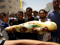 Relatives and friends of the al-Kaware family carry one of the 7 bodies to the mosque during their funeral in Khan Yunis, in the Gaza Strip,...