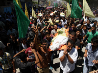 Relatives and friends of the al-Kaware family carry the 7 bodies to the mosque during their funeral in Khan Yunis, in the Gaza Strip, on Jul...