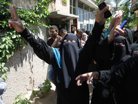 Female members of the al-Kaware family grieve during the funeral for 7 killed members of the family in Khan Yunis, in the Gaza Strip, on Jul...
