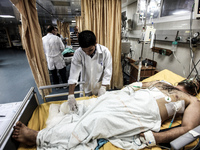 A injured man into a hospital in Gaza City after an Israeli airstrike, on July 10, 2014. The Palestinian death toll has risen to 88 as Israe...