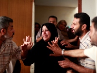 The wife (C) of Palestinian doctor Anas Abu al-Kas, 33, grieves during his funeral in family home in the Jabalia refugee camp in the norther...