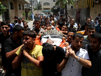 Palestinians carry the body of Islamic Jihad militant Mohammed Sowelim, who was killed in an Israeli air strike, during his funeral in Jabal...