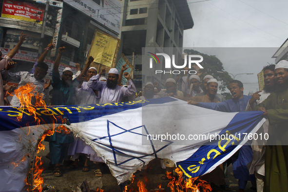 Bangladeshi Muslims made protest by firing in Israeli flag & Israeli product couses of Israeli offensive on the Gaza Strip in front of Natio...