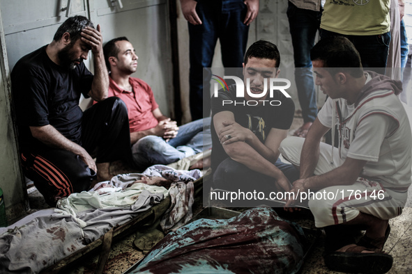 Relatives and friends of a Palestinians militant killed in an Israeli air strike into Gaza City's al-Shifa hospital, on July 12, 2014. The P...
