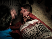 A relative of a Palestinians militant killed in an Israeli airstrike, mourns during his funeral at the family home in Gaza. 12, July 2014. T...