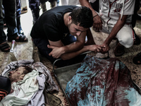 Relatives and friends of a Palestinians militant killed in an Israeli air strike into Gaza City's al-Shifa hospital, on July 12, 2014. The P...