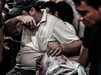 A relative of a Palestinians militant killed in an Israeli airstrike, mourns during his funeral at the family home in Gaza. 12, July 2014. T...