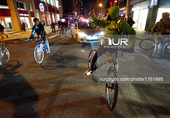 Cyclist participating in a protest bike ride maneuver through Center City traffic in Philadelphia, PA, on Feb. 17, 2017. The cyclist rode in...
