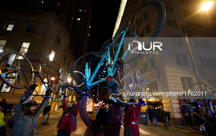 Cyclist lift bikes up in the air after completing an one-hour long bike ride through Center City, Philadelphia, PA, on Feb. 17, 2017. The cy...