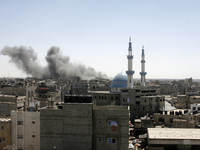 Smoke billows from a building hit by an Israeli air strike in the town of Rafah, in the southern Gaza Strip, on July 14, 2014. The Arab Leag...