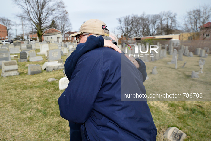 Local neighbor Margaret Bean is seen hugging someone else during a visit of the Mt. Carmel Jewish Cemetery in Northwest Philadelphia, PA, on...