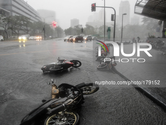 Makati City, Philippines - Motorcycles lie on the road toppled by strong winds as Typhoon Rammasun hit Metro Manila on July 16, 2014. Typhoo...