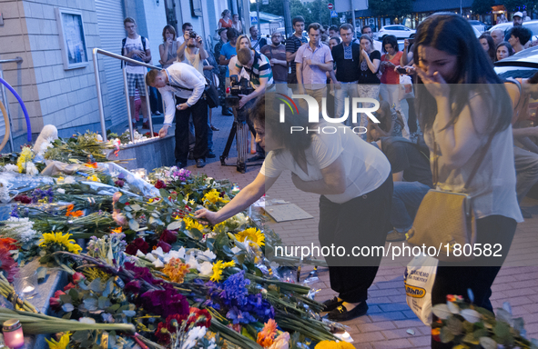 KIEV, UKRAINE - JULY 18: Woman cries as she brings the flowers under the Netherlands Embassy in Kiev feeling for victims of Malaysia Airline...