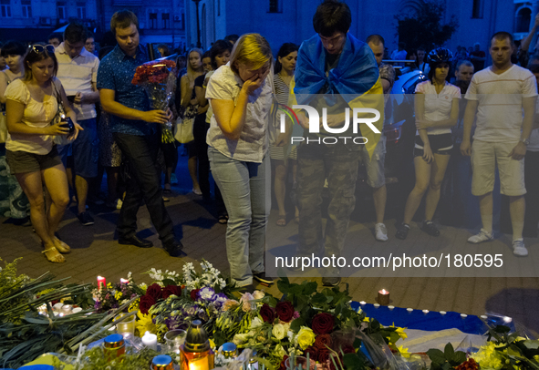 KIEV, UKRAINE - JULY 18: Woman cries as she brings the flowers under the Netherlands Embassy in Kiev feeling for victims of Malaysia Airline...