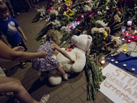 KIEV, UKRAINE - JULY 18: Kid brings her toy bear the Netherlands Embassy in Kiev feeling for victims of Malaysia Airlines plane shot down by...