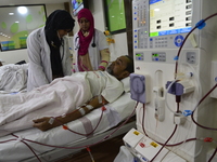 Hospital personnel take care of a patient in a dialysis unit at National Institute of Kidney Diseases and Urology in Dhaka, Bangladesh. On M...