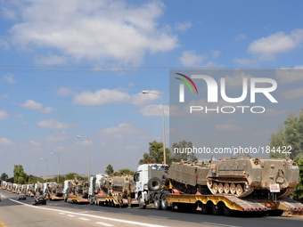 UNSPECIFIED, ISRAEL - JULY 19, 2014: A military convoy carrying APCs near Israel's border with the Gaza Strip, on July 19, 2014,  on the sec...