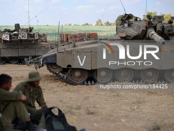 UNSPECIFIED, ISRAEL - JULY 19, 2014: IDF tanks in an army deployment area near Israel's border with the Gaza Strip, on July 19, 2014,  on th...