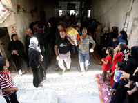 Relatives mourn during the funeral of nine members of the Siam family, who were killed in an Israeli air strike that destroyed their house,...