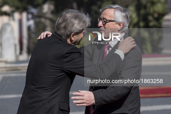 Italian Prime Minister Paolo Gentiloni, left, greets European Commission President Jean-Claude Juncker during arrivals for an EU summit at t...