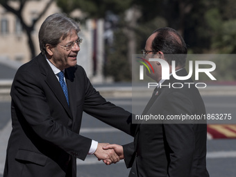 French President Francois Hollande, left, shakes hands with Italian Prime Minister Paolo Gentiloni during arrivals for an EU summit at the P...