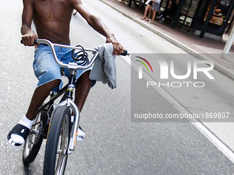 Boy on a bike pulls a Wheelie as he rides in front of a group of cyclist participating in the Sept. 4, 2011 Philly Naked Bike Ride (PNBR), o...