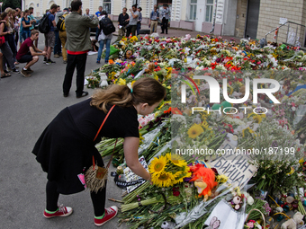 KIEV, UKRAINE - JULY 23: Peple lay flowers in front of Embassy of the Kingdom of The Netherlands in memory of MH-17 air crash victims (