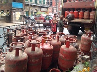 A delivery man loding Liquid Petroleum Gas (LPG) cylinders at Central Kolkata in India ,Subsidised LPG cylinder price hiked by Rs5.57, ATF c...