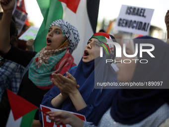 Protestors shout slogans during a demonstration against the Israeli airstrikes of the Gaza strip in front of the Israel Embassy, in Madrid,...