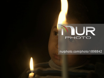 Palestinian boys hold candles during a protest against the blockade on Gaza, in Gaza City April 14, 2017. 
 (