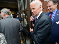 Former Vice President Joe Biden holds open the door as dignitaries enter after the ribbon is cut on the official openings day of the Museum...